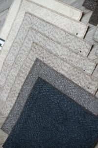 Stacked granite slabs in varying shades from light to dark gray.