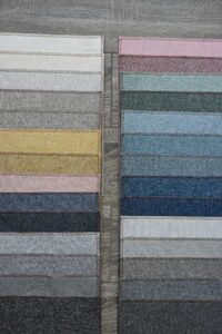Rows of fabric swatches in various colors arranged neatly.