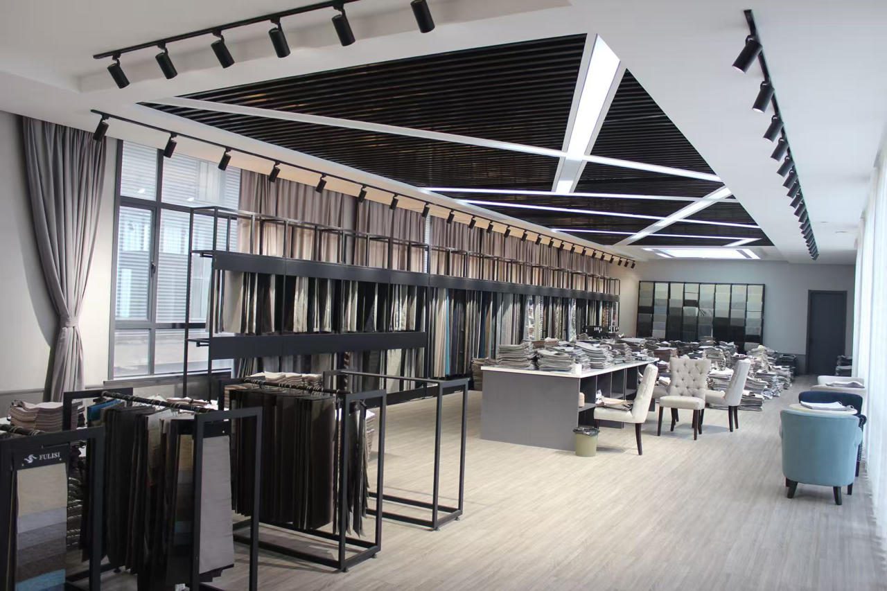 Modern, minimalist retail store interior with clothing racks and display tables.